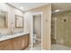 Bathroom boasts a double vanity with granite countertop and frameless glass shower at 1666 Pine Pl, Clearwater, FL 33755
