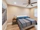 Relaxing bedroom featuring ceiling fan, light walls, hardwood floor and side tables with reading lamps at 1666 Pine Pl, Clearwater, FL 33755