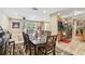 Stylish dining area with hardwood floors, dining table, and an open layout to the kitchen and living area at 1666 Pine Pl, Clearwater, FL 33755