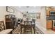 Open-concept dining area with hardwood floors, modern buffet, and easy access to kitchen at 1666 Pine Pl, Clearwater, FL 33755