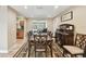 Elegant dining room with hardwood floors, stylish furniture, and views to the pool at 1666 Pine Pl, Clearwater, FL 33755