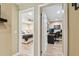 Inviting hallway view into a bedroom and office featuring light-colored walls and hardwood floors at 1666 Pine Pl, Clearwater, FL 33755