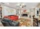 Cozy living room showcasing a fireplace, unique rug, comfortable seating, and expansive world map feature wall at 1666 Pine Pl, Clearwater, FL 33755
