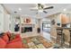 Open concept living space with fireplace, bar seating, unique rug, and a view of backyard pool area at 1666 Pine Pl, Clearwater, FL 33755
