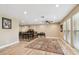 Spacious living room featuring hardwood floors, recessed lighting, and large windows at 1666 Pine Pl, Clearwater, FL 33755