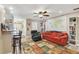 Open-concept living room featuring a colorful rug, comfortable seating, and a unique world map wall decoration at 1666 Pine Pl, Clearwater, FL 33755