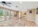 Inviting living room featuring hardwood floors, recessed lights, and views of the outdoors at 1666 Pine Pl, Clearwater, FL 33755