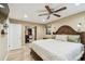 Main bedroom features an ensuite bathroom, a ceiling fan, wood floors, and a walk in closet at 1666 Pine Pl, Clearwater, FL 33755