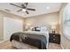 Bedroom showcasing a ceiling fan, hardwood floors, a large bed, and a spacious closet at 1666 Pine Pl, Clearwater, FL 33755
