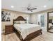 Spacious main bedroom with a ceiling fan, wood floors, and ensuite bathroom at 1666 Pine Pl, Clearwater, FL 33755