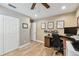 Comfortable office space with fan, featuring wood-look flooring and natural lighting at 1666 Pine Pl, Clearwater, FL 33755