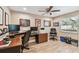 Bright office with a ceiling fan, a large window, and a computer desk with office equipment at 1666 Pine Pl, Clearwater, FL 33755