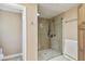 The tile shower features frameless glass, a shower bench, and built-in shelves at 1666 Pine Pl, Clearwater, FL 33755