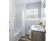Bathroom with a tub/shower combo, gray vanity, and sleek design, enhancing your daily routine at 1713 W Louisiana Ave, Tampa, FL 33603
