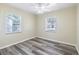Cozy bedroom with two windows offering ample natural light and modern vinyl flooring at 1713 W Louisiana Ave, Tampa, FL 33603