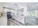 Bright kitchen featuring stainless appliances, subway tile backsplash, and gray flooring at 1713 W Louisiana Ave, Tampa, FL 33603