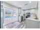 Bright kitchen with stainless appliances, granite counters, and easy access to the pool area at 1713 W Louisiana Ave, Tampa, FL 33603