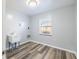 Bright laundry room with wood-look floors, utility sink, connections, and a window for natural light at 1713 W Louisiana Ave, Tampa, FL 33603