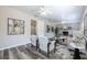 Bright living room features a decorative fireplace, ceiling fan, and luxury vinyl plank flooring at 1713 W Louisiana Ave, Tampa, FL 33603