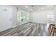 Bright living room featuring gray floors, modern ceiling fan and a large window with natural light at 1713 W Louisiana Ave, Tampa, FL 33603