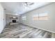 Spacious living room shows off luxury vinyl plank flooring, ceiling fan, and natural light at 1713 W Louisiana Ave, Tampa, FL 33603