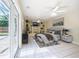 Bright main bedroom features built-in shelving, ceiling fan, and French doors to a screened-in patio at 1713 W Louisiana Ave, Tampa, FL 33603