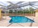 Backyard pool with brick patio and screened enclosure, ideal for outdoor relaxation and recreation at 1713 W Louisiana Ave, Tampa, FL 33603