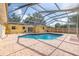 Sparkling backyard pool with a screened enclosure and brick patio perfect for outdoor entertaining at 1713 W Louisiana Ave, Tampa, FL 33603