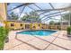 Inviting screened-in pool area with brick pavers and a covered patio, perfect for outdoor relaxation at 1713 W Louisiana Ave, Tampa, FL 33603