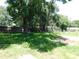 Backyard surrounded by a wooden fence and mature trees provides privacy at 17236 Spring Valley Rd, Dade City, FL 33523