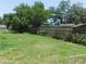 Spacious, grassy backyard enclosed by a wood fence and lush greenery provides privacy at 17236 Spring Valley Rd, Dade City, FL 33523