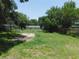 Large backyard with lush green lawn and mature trees offers ample outdoor space at 17236 Spring Valley Rd, Dade City, FL 33523