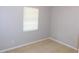 Cozy bedroom with neutral tiled floor, a window that provides natural light, and neutral colored walls at 17236 Spring Valley Rd, Dade City, FL 33523