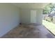 A gray carport features a single white door, offering sheltered parking and storage space at 17236 Spring Valley Rd, Dade City, FL 33523