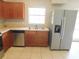 Spacious kitchen featuring stainless steel appliances, light countertops, and stylish cabinets at 17236 Spring Valley Rd, Dade City, FL 33523