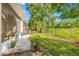 Landscaped backyard with a view of the patio, grass, and fenced perimeter. Great for outdoor enjoyment at 1749 Sedgefield Ct, Odessa, FL 33556