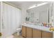 Clean bathroom with a marble countertop, decorative mirror, and shower with curtain at 1749 Sedgefield Ct, Odessa, FL 33556