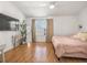 Bright bedroom with light walls, wood floors, a ceiling fan, and a large window at 1749 Sedgefield Ct, Odessa, FL 33556