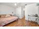 Bright bedroom with wood floors, a desk, and ample natural light at 1749 Sedgefield Ct, Odessa, FL 33556