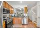 Kitchen with stainless steel appliances and view of stairs at 1749 Sedgefield Ct, Odessa, FL 33556