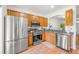 Well-equipped kitchen with stainless steel appliances and warm wooden cabinets at 1749 Sedgefield Ct, Odessa, FL 33556