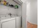 Clean laundry area with washer, dryer, and wire shelving for storage at 1749 Sedgefield Ct, Odessa, FL 33556