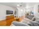 Open concept living area with hardwood floors, access to the kitchen and a comfortable gray couch at 1749 Sedgefield Ct, Odessa, FL 33556