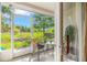 Relaxing screened porch with seating offers a serene view of the backyard and landscaping at 1749 Sedgefield Ct, Odessa, FL 33556