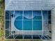 Aerial view of a screened in swimming pool showing the shape and size at 1802 Oak Ridge Rd, Safety Harbor, FL 34695