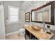 Updated bathroom with granite countertop, vessel sink, and decorative mirror at 1802 Oak Ridge Rd, Safety Harbor, FL 34695