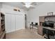 Cozy bedroom space with a ceiling fan, white closet doors, and neutral carpet at 1802 Oak Ridge Rd, Safety Harbor, FL 34695