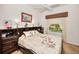 Bedroom featuring a decorative duvet cover, wooden furniture and neutral carpet at 1802 Oak Ridge Rd, Safety Harbor, FL 34695