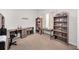 Bedroom featuring gray wooden desk with bookshelves and neutral carpet at 1802 Oak Ridge Rd, Safety Harbor, FL 34695