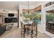 Cozy breakfast nook with pool views, seamlessly connected to the living area and kitchen at 1802 Oak Ridge Rd, Safety Harbor, FL 34695